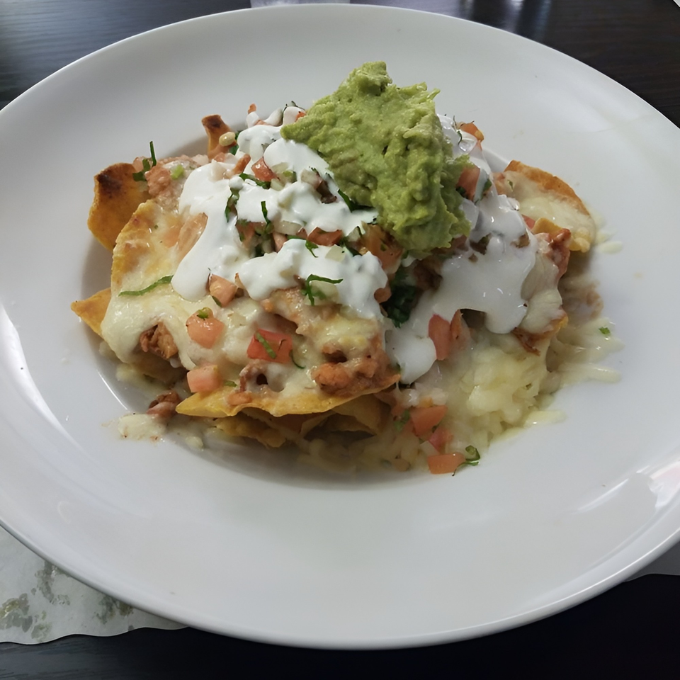 Mi Favorito Mexican Restaurant's nachos with melted cheese, sour cream, guacamole, and pico de gallo.